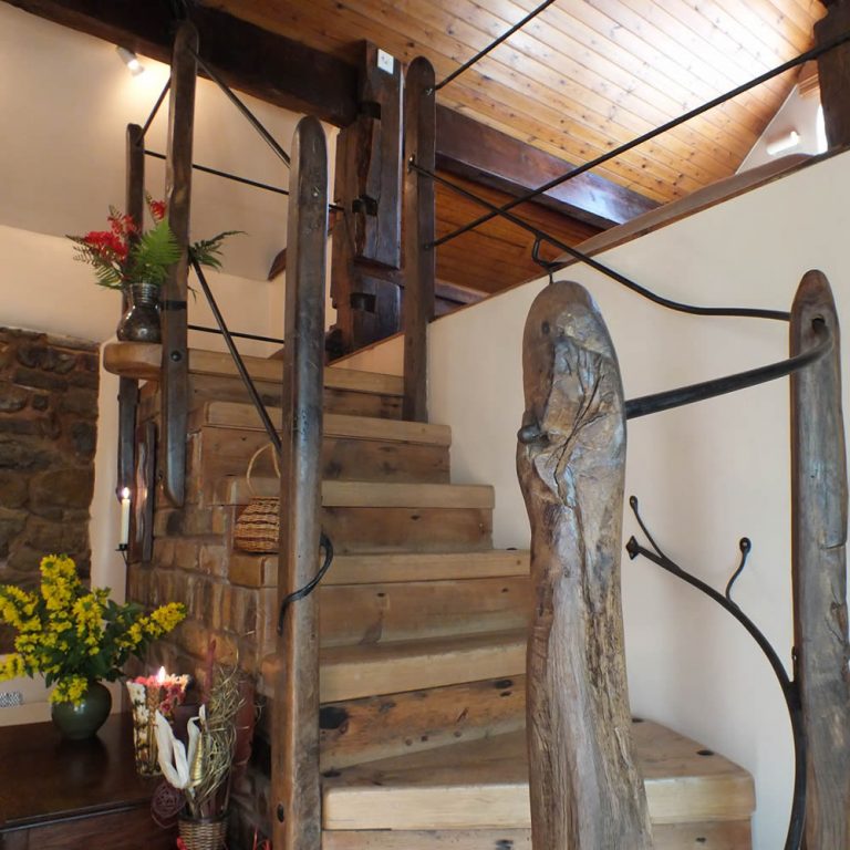 The Saddlery - rustic staircase to gallery bedroom
